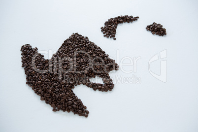 Coffee beans forming cup and saucer shape