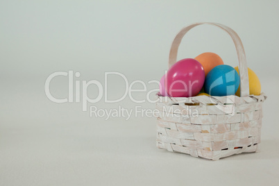 Various Easter eggs in wicker basket