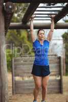 Fit woman climbing monkey bars