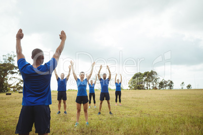 Fit people performing stretching exercise