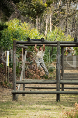 Soldier climbing monkey bars