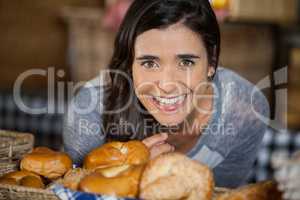 Smiling woman looking at breads in counter