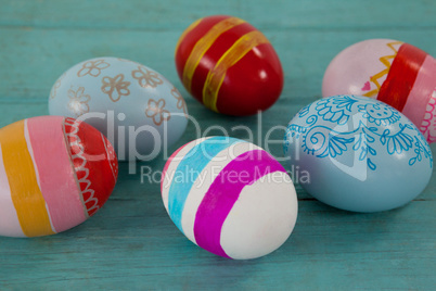 Various Easter eggs on wooden surface