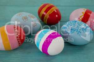Various Easter eggs on wooden surface