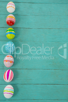 Painted Easter eggs on wooden plank