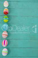 Painted Easter eggs on wooden plank