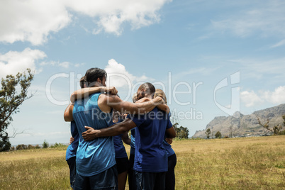 Fit people standing together and forming a hurdle