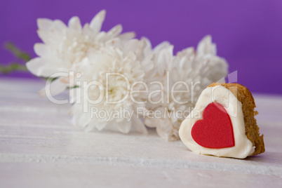 Heart shape easter gingerbread cookie on white table