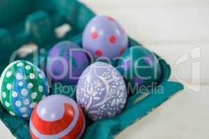 Multicolored Easter eggs in the carton