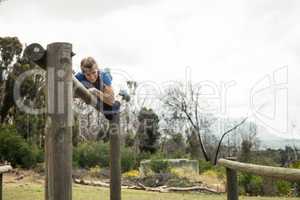 Woman jumping over the hurdles during obstacle course