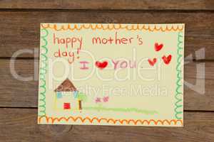Happy mothers day greeting card on wooden background