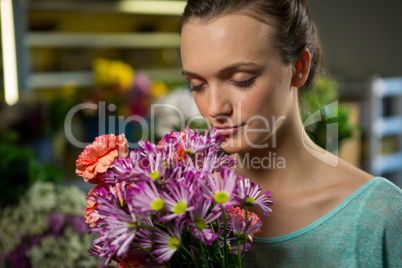 Woman smelling a bunch of flowers