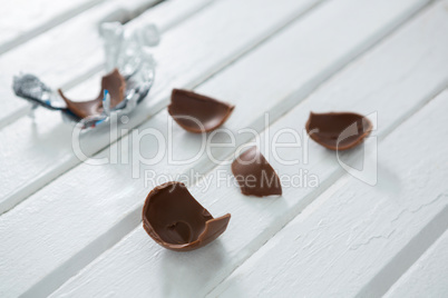 Broken chocolate Easter on wooden surface
