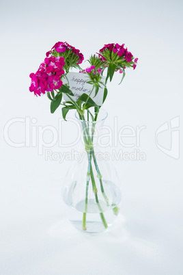 Bunch of pink roses with happy mothers day tag in flower vase