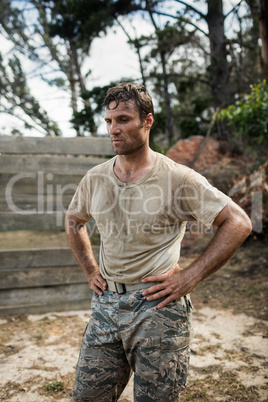 Soldier sitting on his knees with hands on his hip