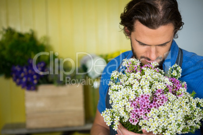 Florist holding bunch of flower in florist shop