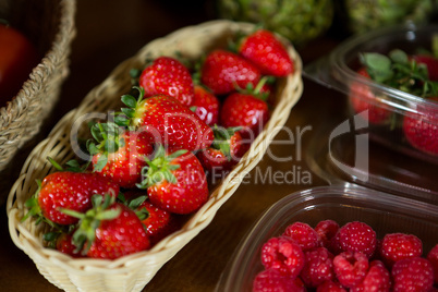 Close-up of small wicker basket full of strawberry at organic section