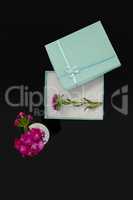 Opened gift box with flower and vase