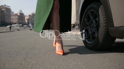 Sexy woman's legs in high heels walking in street