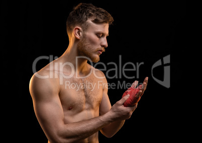 Young fighter man with boxing bandages