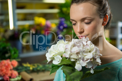 Woman smelling a bunch of flowers