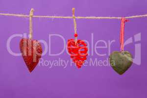 Hearts with different designs hanging on rope
