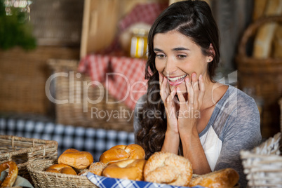 Smiling woman looking at breads in counter