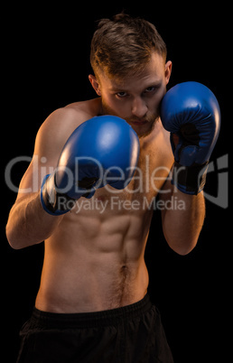 Bearded young man with boxing gloves