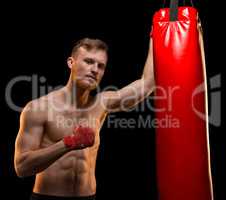 Young boxer man with punching bag