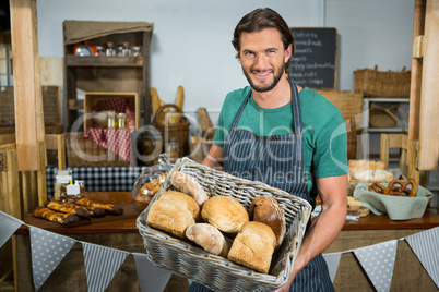Portrait of male staff holding a basket of bread Portrait of male staff holding a basket of bread