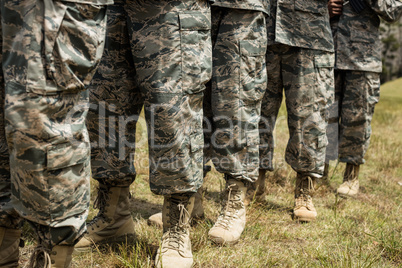 Low-section of military soldiers standing in line