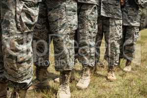 Low-section of military soldiers standing in line