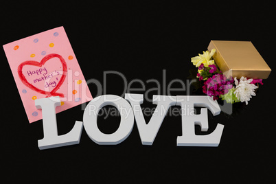 Greeting card, gift box and alphabet love on black background
