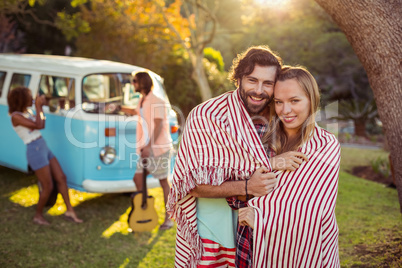 Couple wrap themselves in blanket