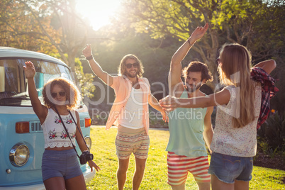 Group of friends dancing in the park