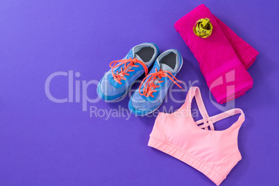 Sneakers, sports bra, towel and measuring tape