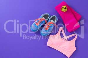 Sneakers, sports bra, towel and measuring tape