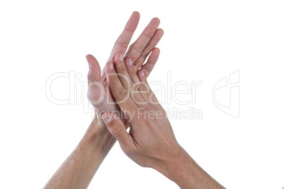 Hands with palms rubbing together against white background