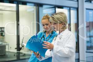 Female doctor and nurse looking at a medical report