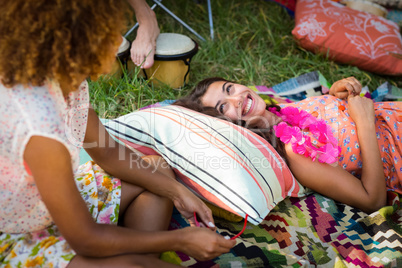 Friends interacting with each other at campsite