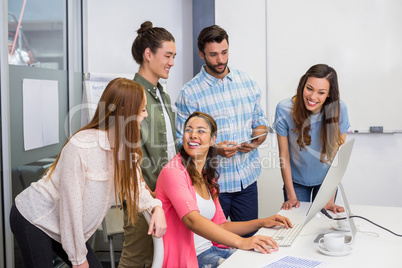 Executives discussing over computer in conference room