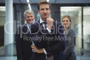 Businessman with hand on chin standing in the office