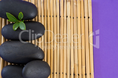 Stones with leaf kept on bamboo mat