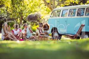 Group of friends having fun together near campervan