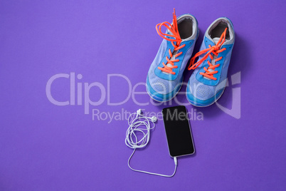 Sneakers, mobile phone with headphones