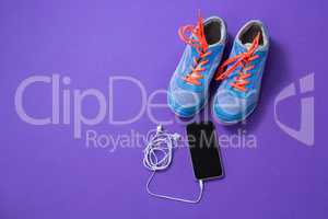 Sneakers, mobile phone with headphones