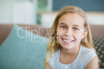 Portrait of a happy girl relaxing on sofa