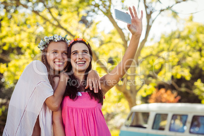 Friends clicking selfie on mobile phones