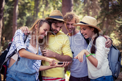 Woman showing mobile phone to friends