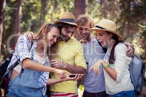 Woman showing mobile phone to friends